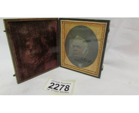 A miniature portrait of a man in a box frame.