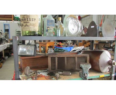 Two shelves of miscellaneous bottles, tools, vice etc.,