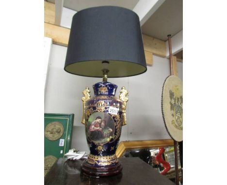 A hand painted classical style table lamp with shade.