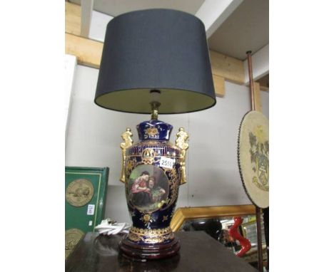 A hand painted classical style table lamp with shade.