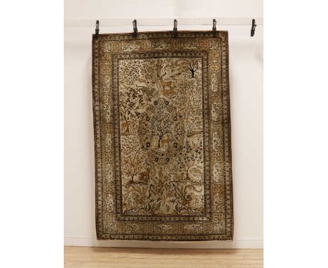 A Persian silk rug,first half of the 20th century, possible Isfahan or Qum, decorated with animals and foliate scrolls,209 x 