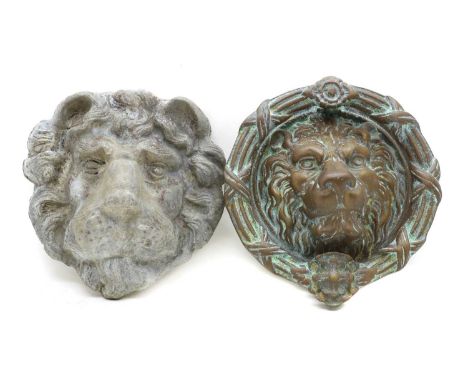 A cast bronze lions head door knocker, of typical form 23cm diameter,together with a cast lead lions head21cmCondition Report