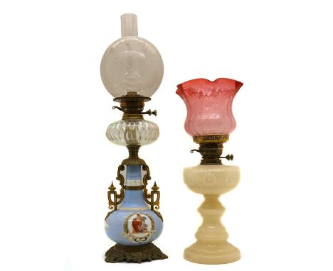 A Victorian opaline glass oil lamp,moulded with stylised flowerheads, below a graduated cranberry acid etched shade,57.5cm hi