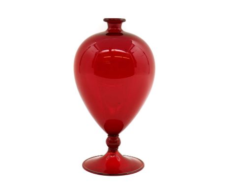 A Veronese style glass vase,after the original design by Vittorio Zecchin in 1921, the ruby red glass body raised on a red kn