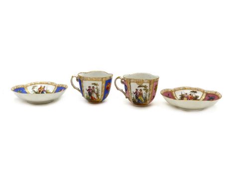  A near pair of Dresden cabinet cups and saucers,late 19th century, with painted figural reserves, bearing the Augusters Rex 