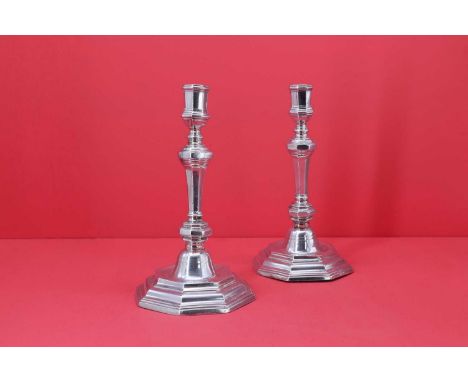 A near pair of cast silver candlesticks,maker's mark distorted, French, Paris 1717-1722, each of plain octagonal baluster for