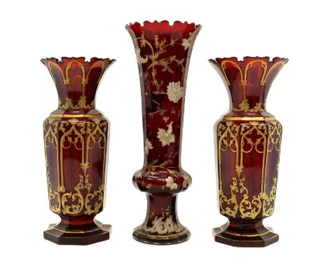 A pair of Bohemian glass vases,late 19th century, each a cut rim and gilt decoration to a deep ruby ground,30.5cm high,togeth