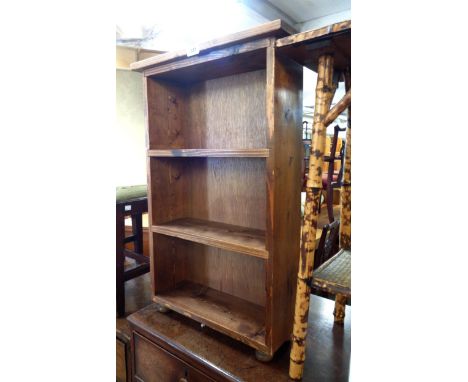 A 40cm stained mixed wood three shelf open bookcase, set on turned knob feet