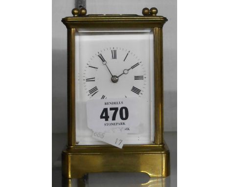 An old brass and bevelled glass cased carriage clock with eight day bell striking movement