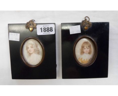 A pair of ebonised and acorn finial framed oval portrait miniature prints