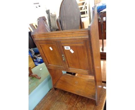 A 43cm Edwardian polished oak wall mounted or freestanding two door cabinet with shelf under