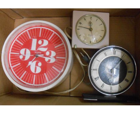 Two vintage electric timepieces and a battery wall clock