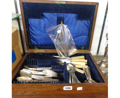 A vintage oak canteen containing assorted silver plated cutlery and two pairs of silver sugar tongs