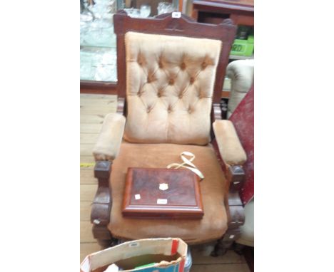 A late Victorian walnut part show frame drawing room armchair with incised decoration and button back upholstery, set on turn