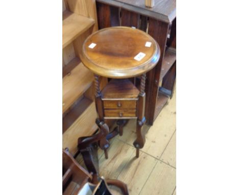 A Far Eastern hardwood jardiniere stand with two small triangular drawers, set on slender supports and tripod base