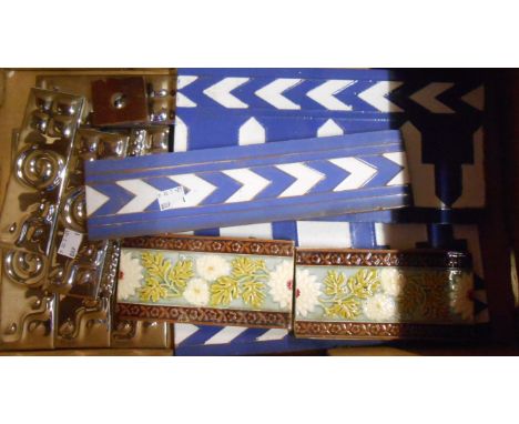 A box containing assorted ceramic fireplace surround tiles