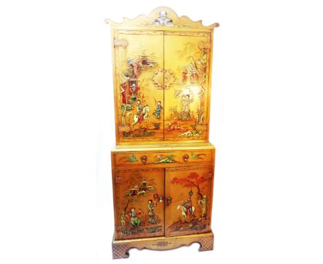 A 78cm vintage chinoiserie cabinet with shaped pediment, two pairs of cupboard doors and central drawer, with raised painted 