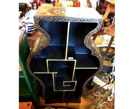A 64cm late Chinese bombe pedestal display stand with gilt and black lacquered decoration and an array of open shelves, set o