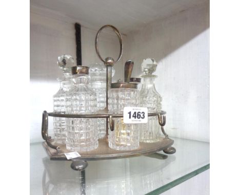 A silver plated hobnail glass six bottle cruet set on stand