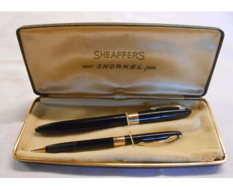 A vintage cased Scheaffer snorkel fountain pen and pencil set