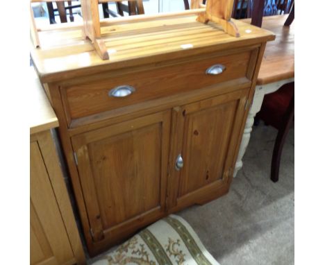 A 90cm modern polished pine dresser base with long frieze drawer over double cupboard, set on bracket base