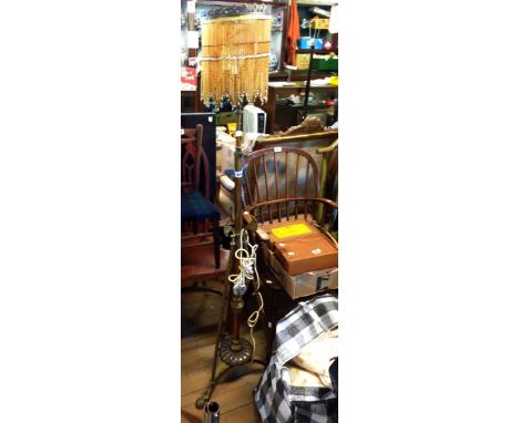 A late Victorian brass telescopic lamp standard with beaded shade and ornate tripod base - converted to electricity