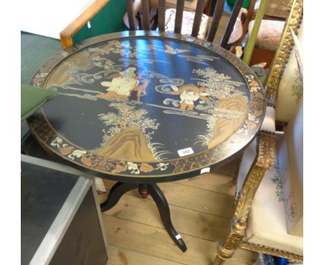 A 76cm diameter late Chinese lacquered tilt-top pedestal table with decoration featuring an Immortal amidst clouds, set on tu