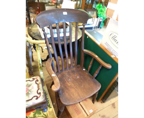 An antique elm high lathe back Windsor elbow chair with solid moulded seat, set on ring turned  supports