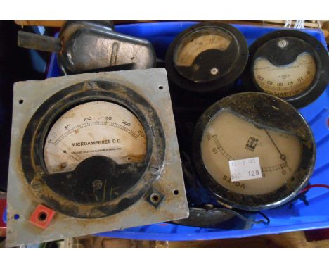 A box containing a quantity of ammeters, voltmeters, car dashboard clock, etc.