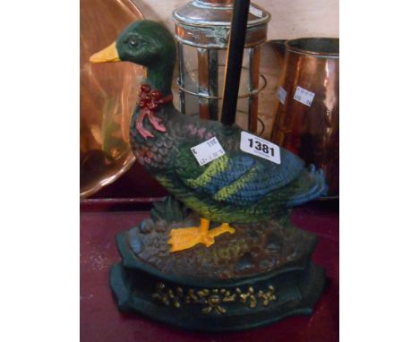 A modern cast iron painted duck form door stop