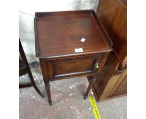 A 41cm 19th Century mahogany pot cupboard with panelled door, set on raised turned legs - base board replaced