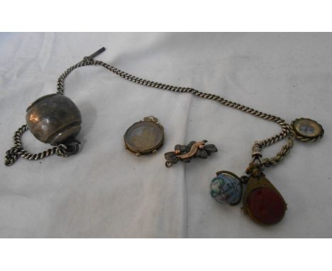 A silver watch chain with silver bell, enamelled globe of the world, compass and other fobs