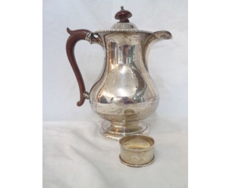 A silver baluster hot water jug with engraved dates to front - Birmingham 1930 - sold with a silver napkin ring