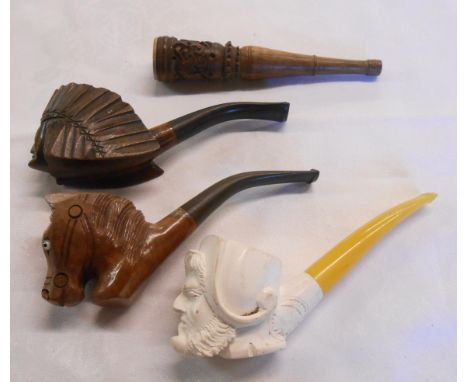 A Meerschaum pipe carved as a man smoking a pipe with amber stem - sold with a carved briar wood pipe in the form of a Native