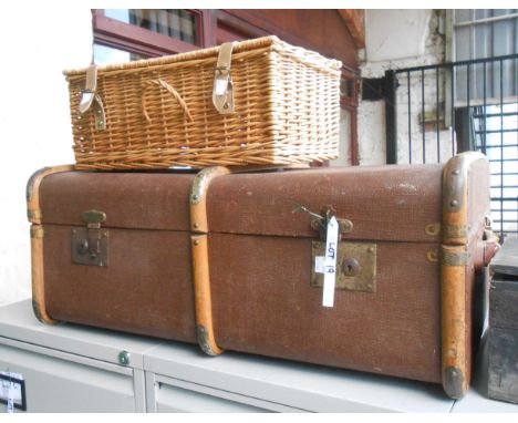 A vintage cane bound and canvas weather coated travelling trunk - sold with a modern wicker picnic hamper