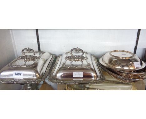 A pair of silver plated entree dishes and covers with detachable ornate cast handles and family initials - sold with a pair o