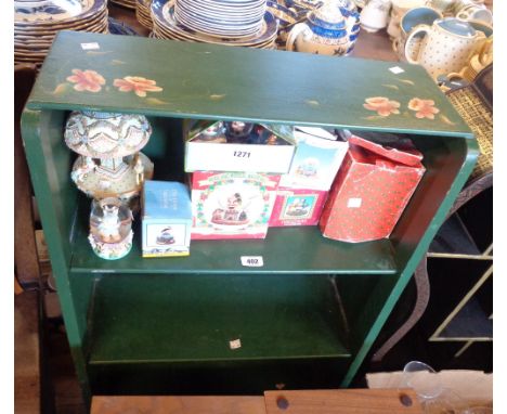 A 61cm 20th Century painted wood three shelf open bookcase with trailing floral decoration on green ground