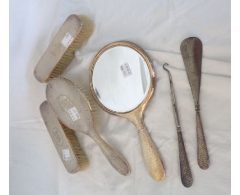 A silver mounted dressing table hand mirror and brush set, also button hook and shoehorn - various condition