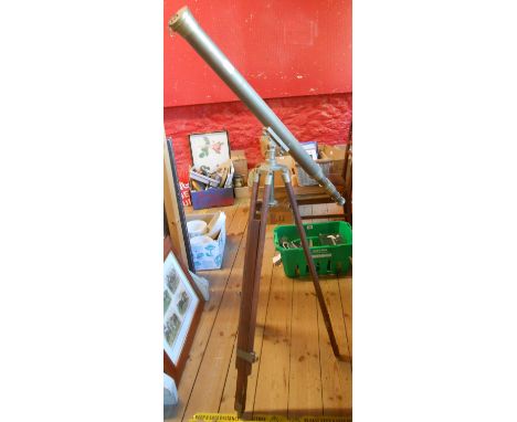 A large reproduction brass telescope on wooden tripod