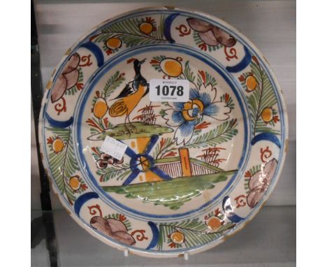 An 18th Century Bristol Delftware plate, depicting a bird sitting on a fence - old restoration