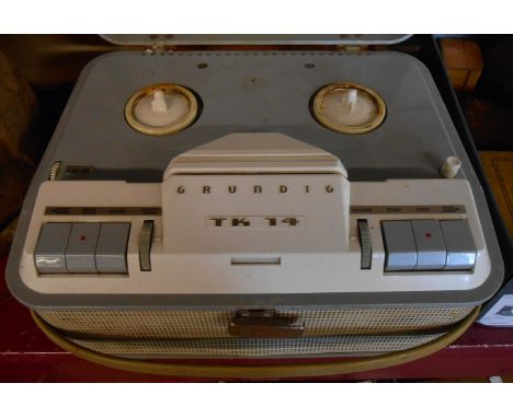 A vintage Grundig TK14 reel-to-reel tape recorder and tape reel can