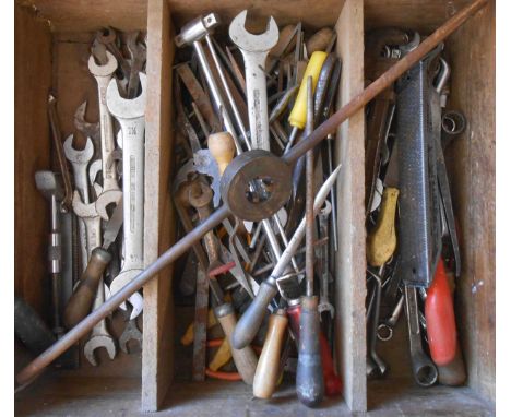 A furniture drawer containing assorted woodworking and other tools including rasps, snips, spanners, etc.