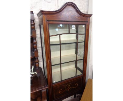 A 64cm Edwardian walnut and strung display cabinet with material lined interior enclosed by a glazed panel door, set on slend