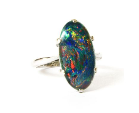 A single stone black opal triplet ring, claw set to a plain polished shank, marked 18ct (tested and valued as 18ct), size K l