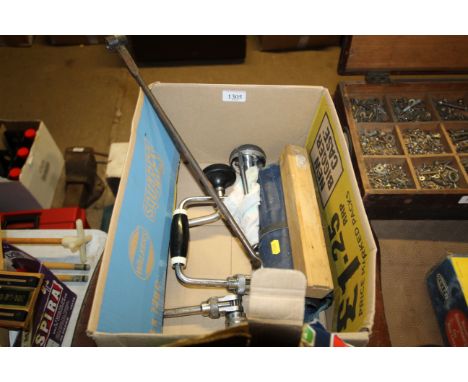 A box containing various tools to include hand braces, auger, drill bits etc.