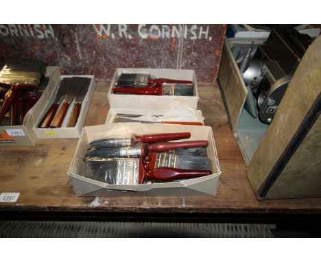 Two boxes containing a quantity of Hamilton's 902 paint brushes 1½" scale Tang chisel knives 
