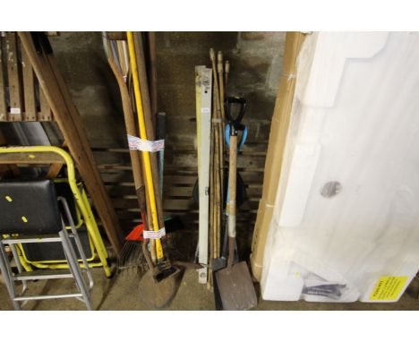 A quantity of various tools to include two spirit levels, cane drain rods, two shovels, folding stool etc
