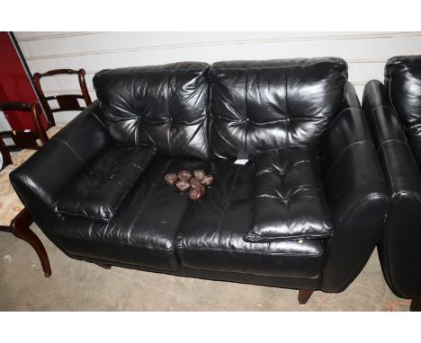 A black leatherette button two seat sofa