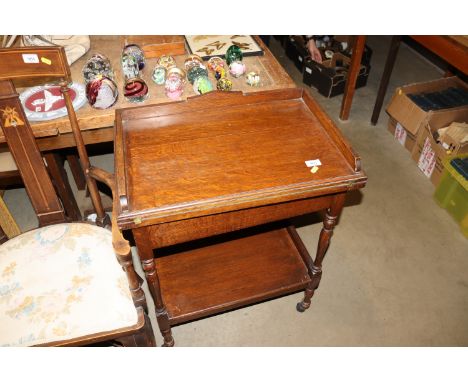 An oak folding swivel top trolley /  card table