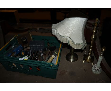 A crate containing a quantity of tools to include quick release clamp, cordless drill, twine, smoothing plane, bulb planter, 